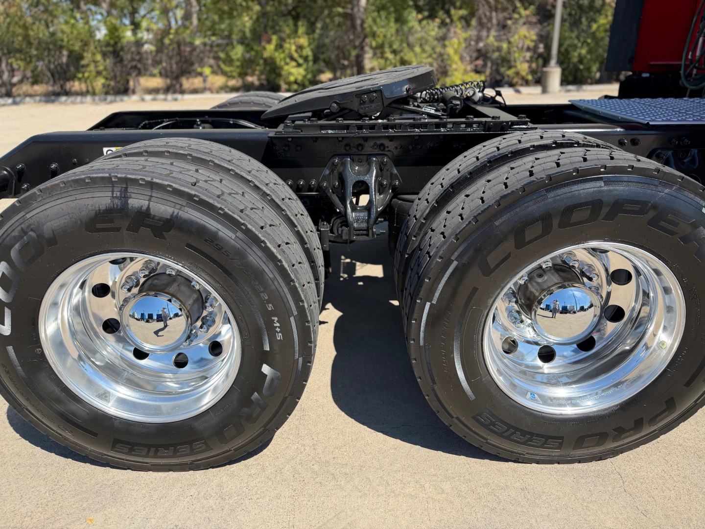 Kenworth T680 rear wheel area showing dual rear tires and chrome wheels with Goodyear tires.