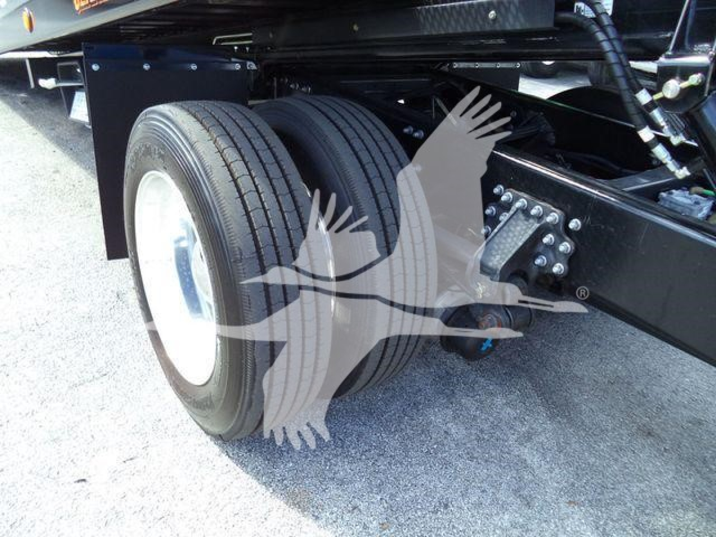 Mack MD6 truck rear dual wheels and suspension showing twin tires and chassis components.