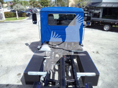 MD6 truck cab view showing chassis with two black tool/storage boxes and frame rails, blue cab with window, front dual mirrors visible.