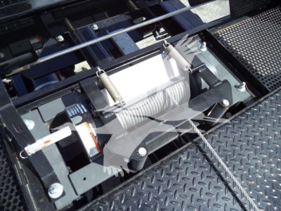 Trucks equipment image showing winch/hoist mechanism with steel cable on a Mack MD6 rollback truck, with diamond plate platform and winch drum visible.