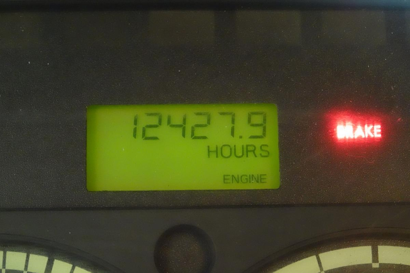 Dashboard hour meter showing 12427.9 hours and MAKE indicator lit.