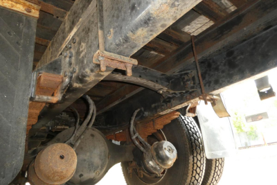 Freightliner M2-106 undercarriage showing rear axle, differential, suspension, and chassis frame with signs of use.