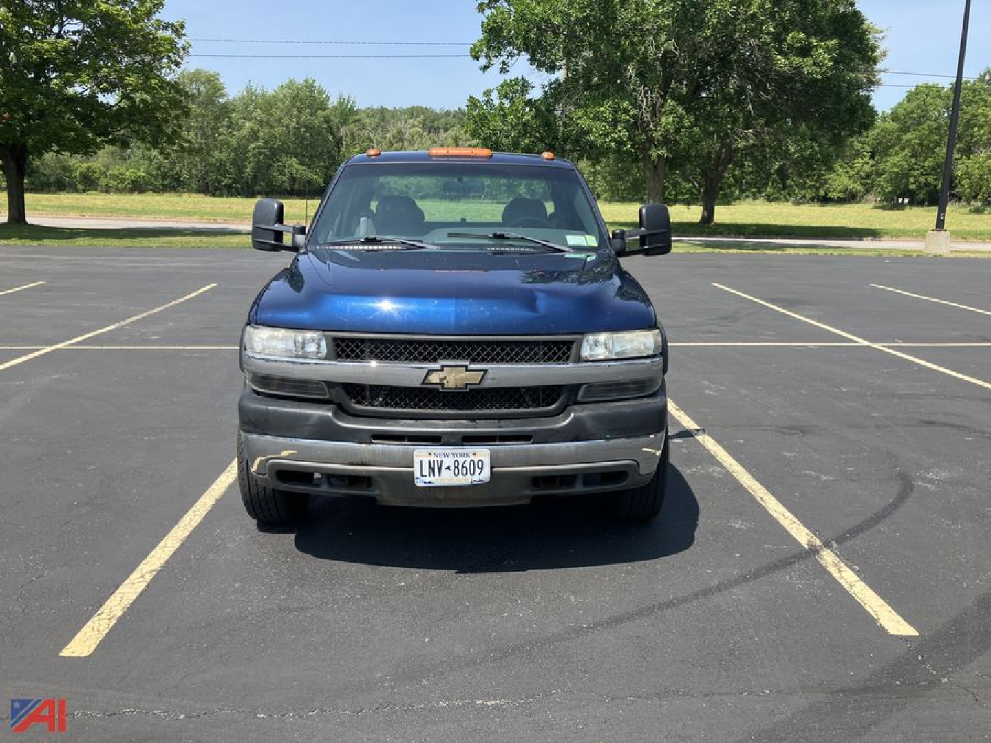 Chevrolet Silverado 2500HD front view showing grille, headlights, and bumper in parking lot.