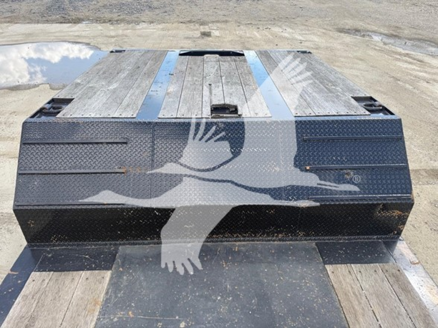 Trailer deck showing dual-drop expandable trailer with wooden deck and metal end walls, black frame, watermarked with overlapping eagle graphic.