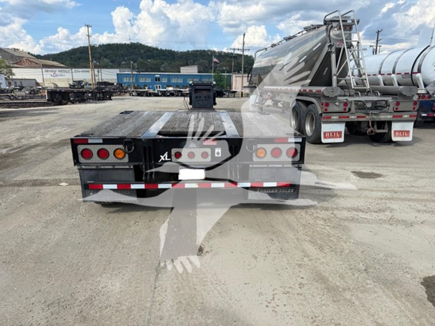 Rear view of XL Specialized HDGM trailer showing dual rear taillights and bumper with reflective tape.