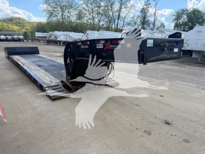 XL Specialized HDGM trailer with double drop expandable gooseneck and flatbed ramp in a lot, visible VIN and stock tags.