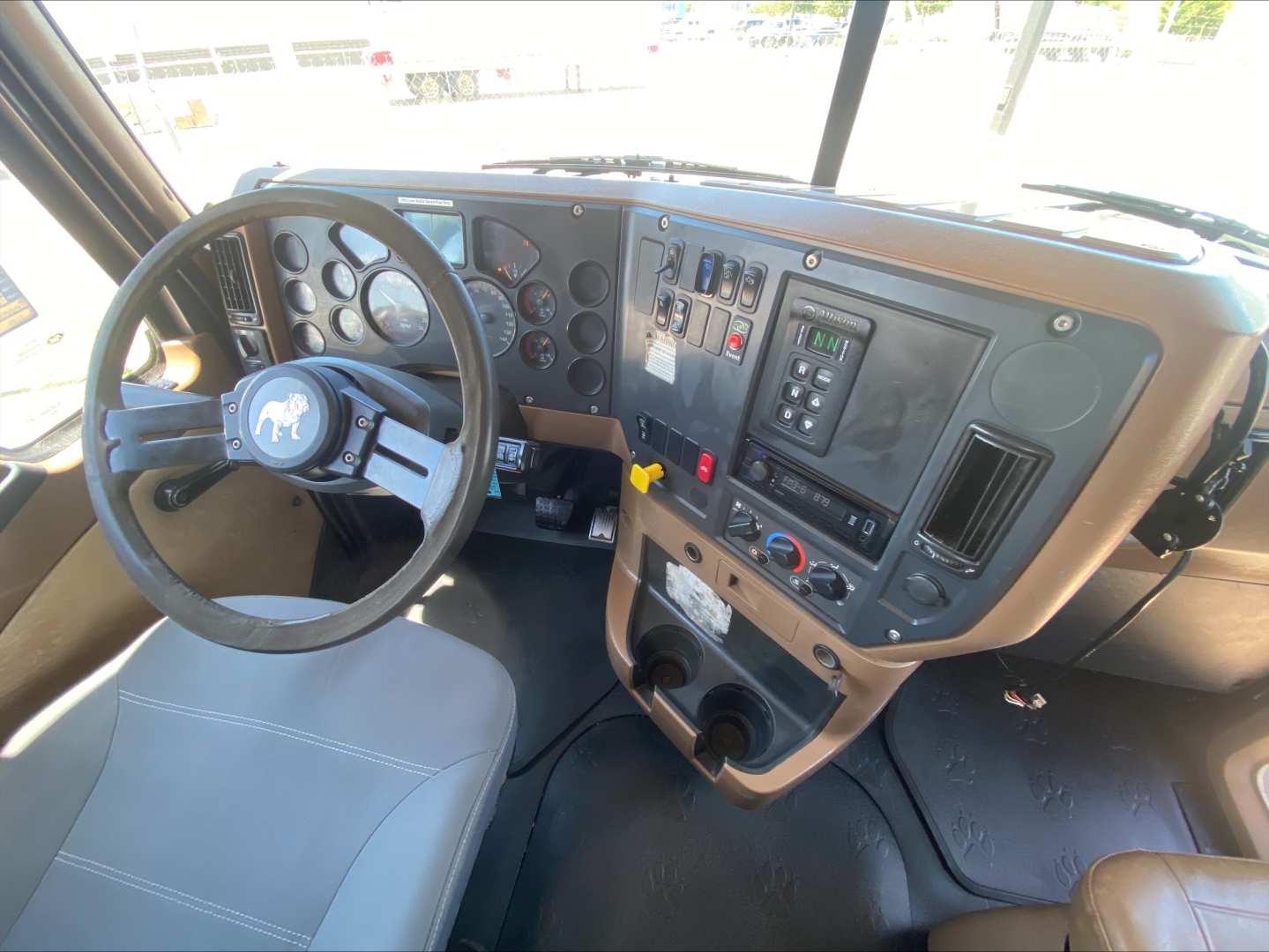 Cab interior of a 2016 Mack GU533 showing dashboard gauges and steering wheel.