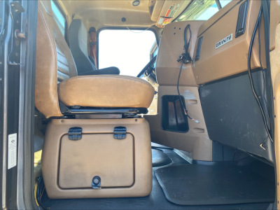Cab interior of 2016 Mack GU533 truck showing operator seat and dashboard with 'GRANITE' label on panel.