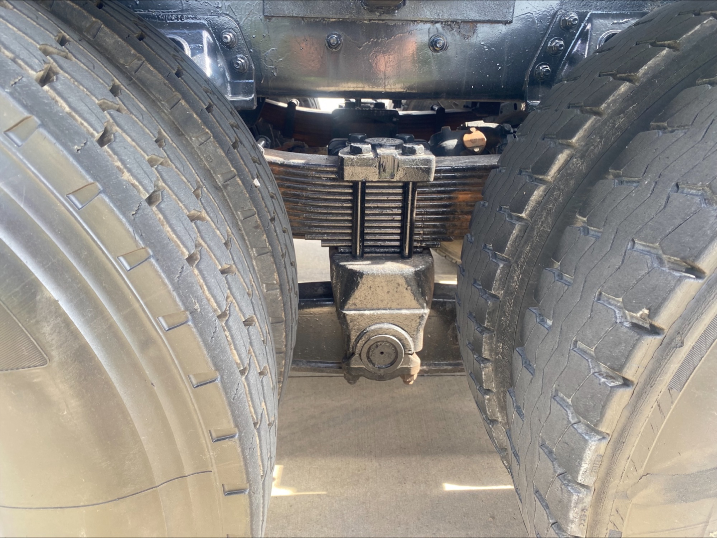 Freightliner M2 rear view showing dual rear axle suspension with leaf springs and differential housing.