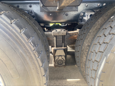 Freightliner M2 rear axle and dual tires showing suspension and leaf springs with driveline components.
