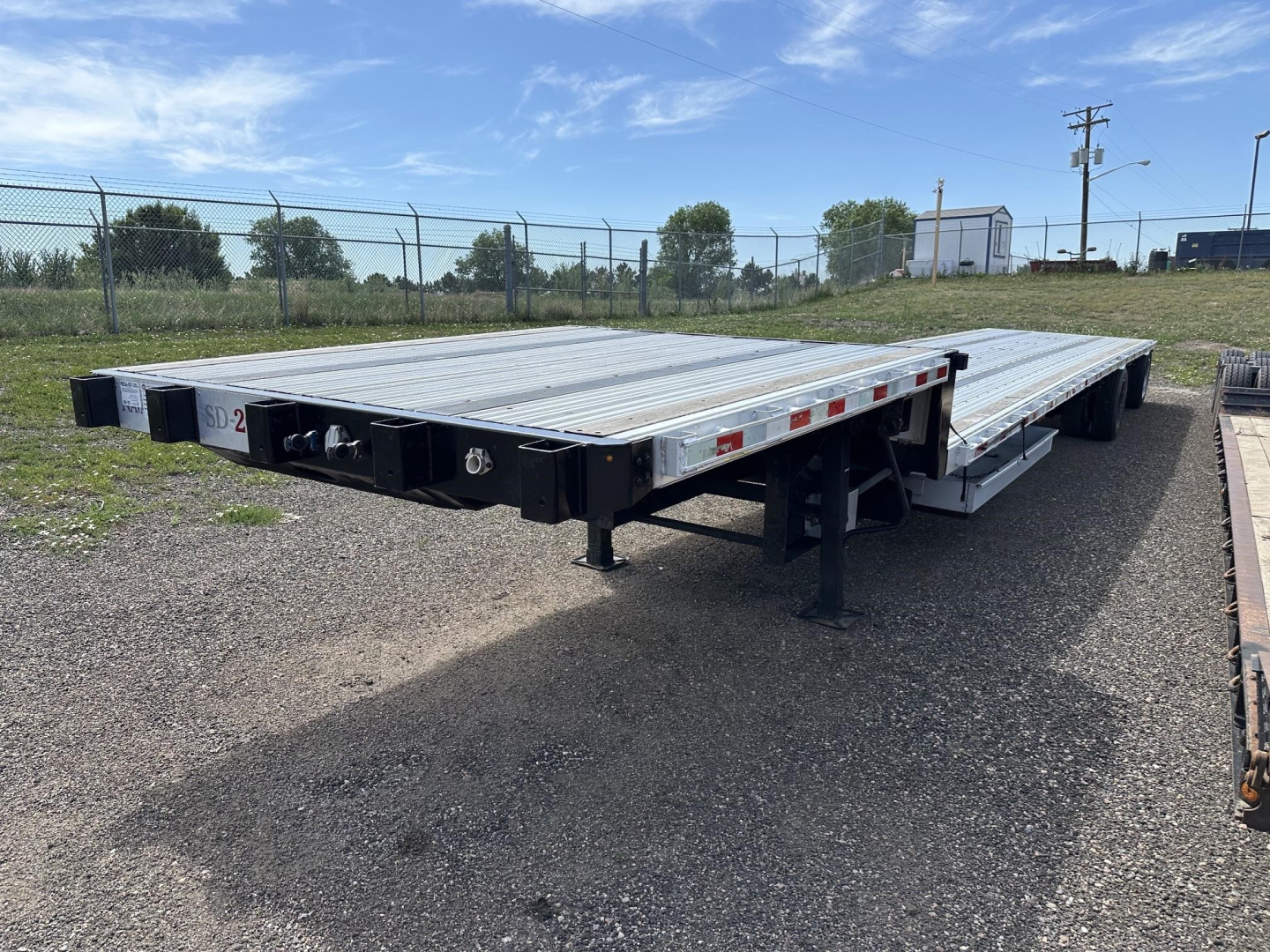 Great Dane combo spread air drop deck trailer showing dual flatbed deck with silver aluminum surface and black undercarriage.