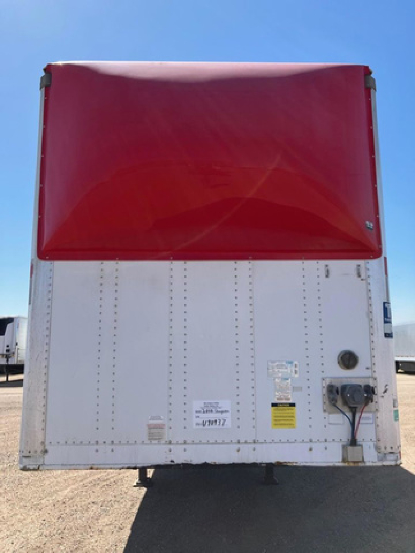 Rear view of a 2016 Stoughton van trailer with a red top hatch and white lower body, showing stickers, electrical connection, and safety labels.