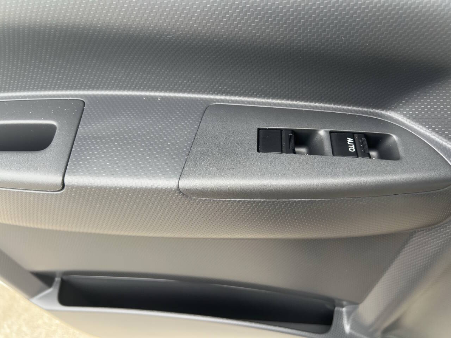 Chevrolet 4500 HD truck interior door panel showing power window switch and textured door trim.