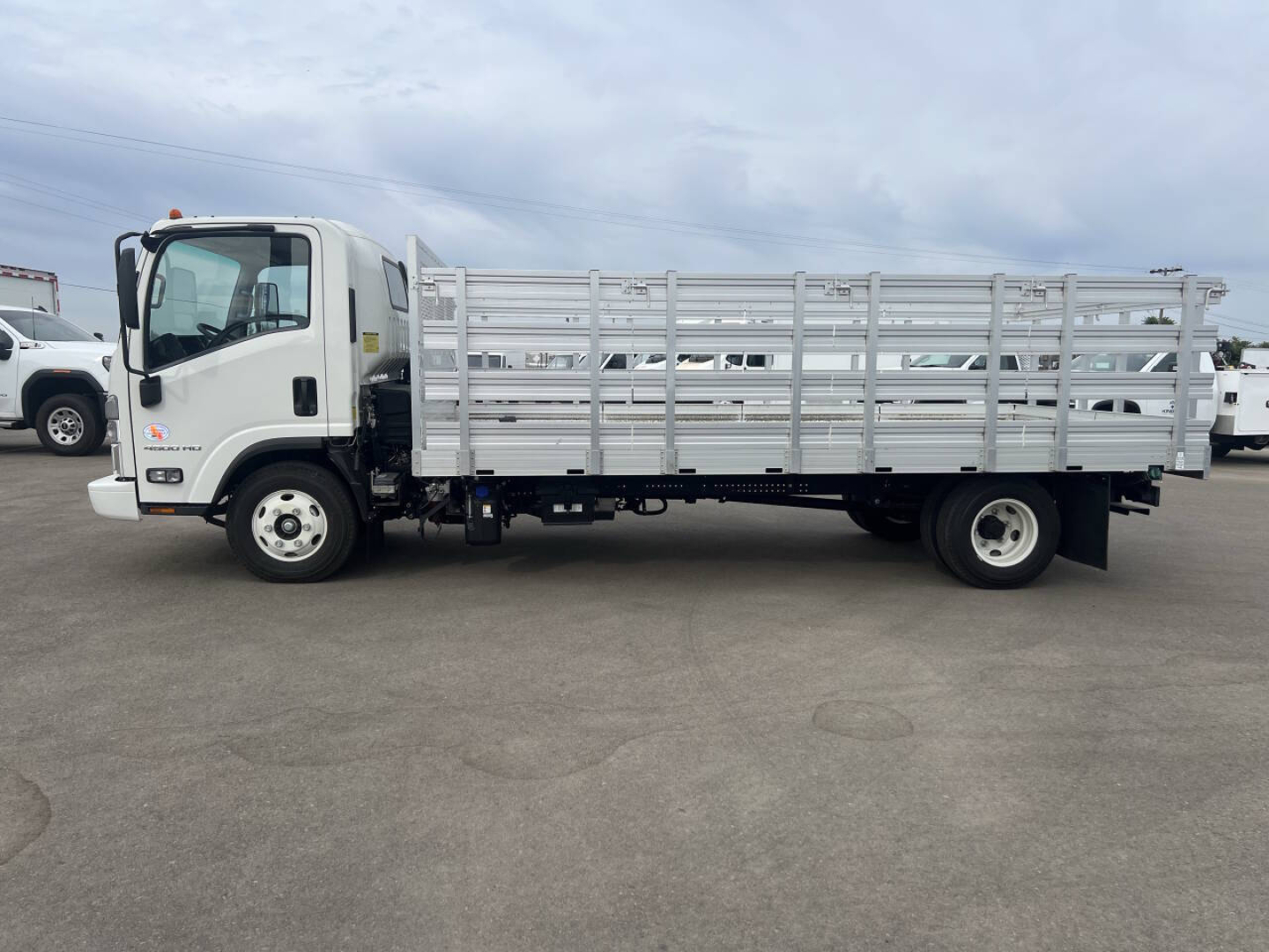 Flatbed truck with aluminum stake body and cab in view; Chevrolet 4500HD type truck.