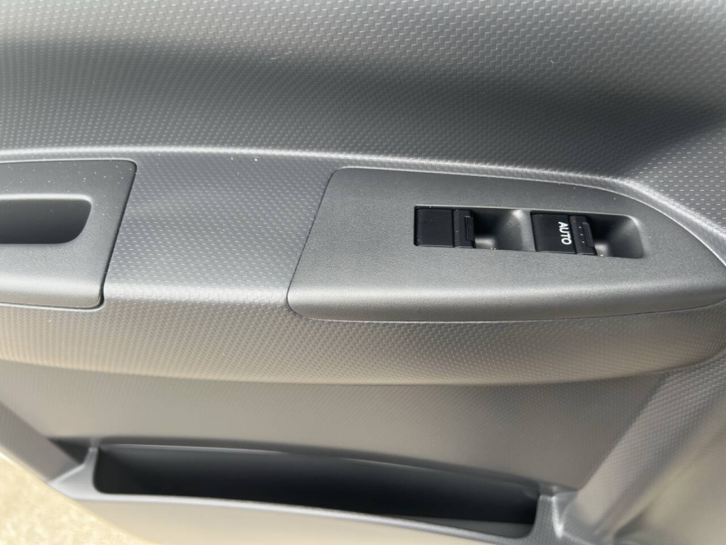 Chevrolet 4500 HD truck interior door panel showing power window switch and textured door trim.