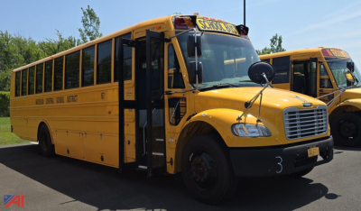 School bus 2018 Freightliner Thomas B2 C2 exterior view showing yellow body, black bumper, bus door open, safety mirrors, and stop sign area.