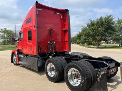 Kenworth T680 tractor rear and cab side view with red sleeper, dual rear axles, chrome wheels, and visible hydraulic lines.