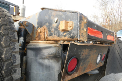 Truck hitch area of a 2004 International 9400 cab with dirt and wear showing rear frame and fuel tank