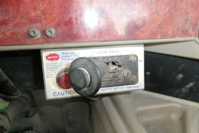 Truck cab area showing ignition/neutral selector with label reading Power Take and caution text, used International 9400 dump panel