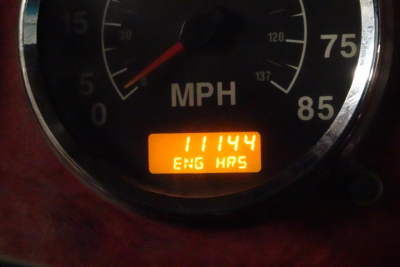 Speedometer gauge showing MPH with an orange digital display reading 'ENG  HRS' and numbers '111144' visible.