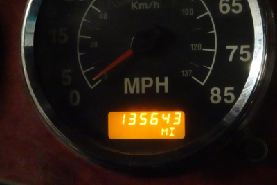 Speedometer gauge with orange odometer reading 135643 miles visible.