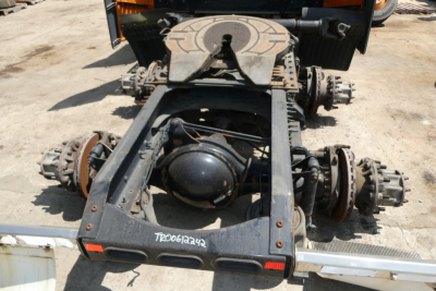 Rear view of Volvo VNR64T300 chassis showing fifth wheel and drive axles, with drivetrain components and suspension visible.