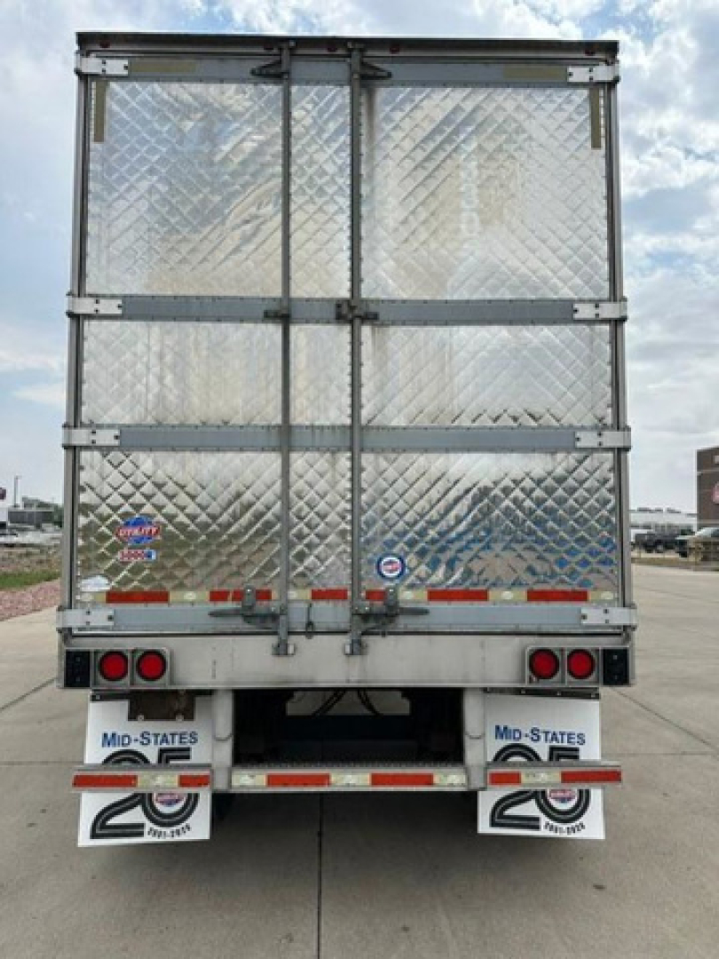 refrigerated trailer rear view showing diamond plate doors, hinge bars, and taillights with Utah license plates visible