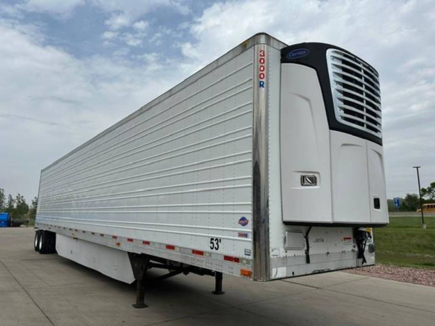 Reefer trailer with front refrigeration unit and 'DOOR' label on corner post, 53' length, aluminum siding, parked on lot.