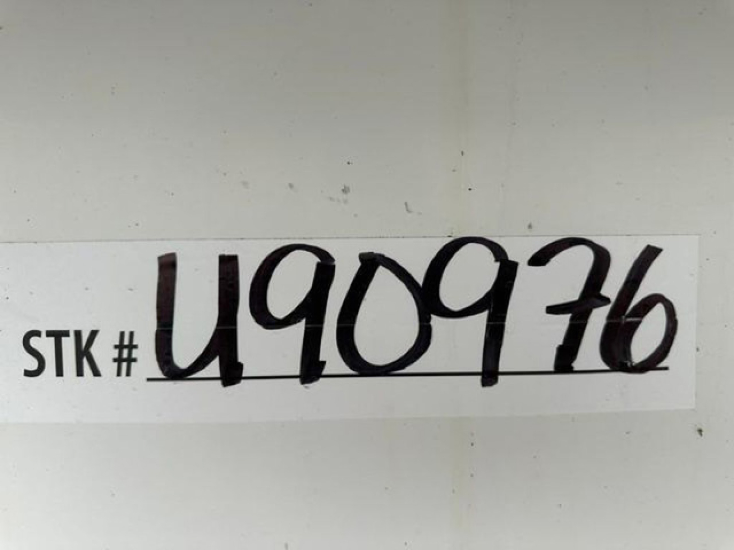 STK # U909716 sticker on a white surface