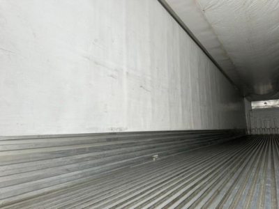 Trailer interior showing ribbed floor and white sidewalls of a refrigerated trailer (referred to as a 2016 Utility Reefer).