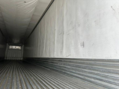 Trailer interior showing ribbed floor and side walls of a 2016 refrigerated trailer (reefer) with open rear door.