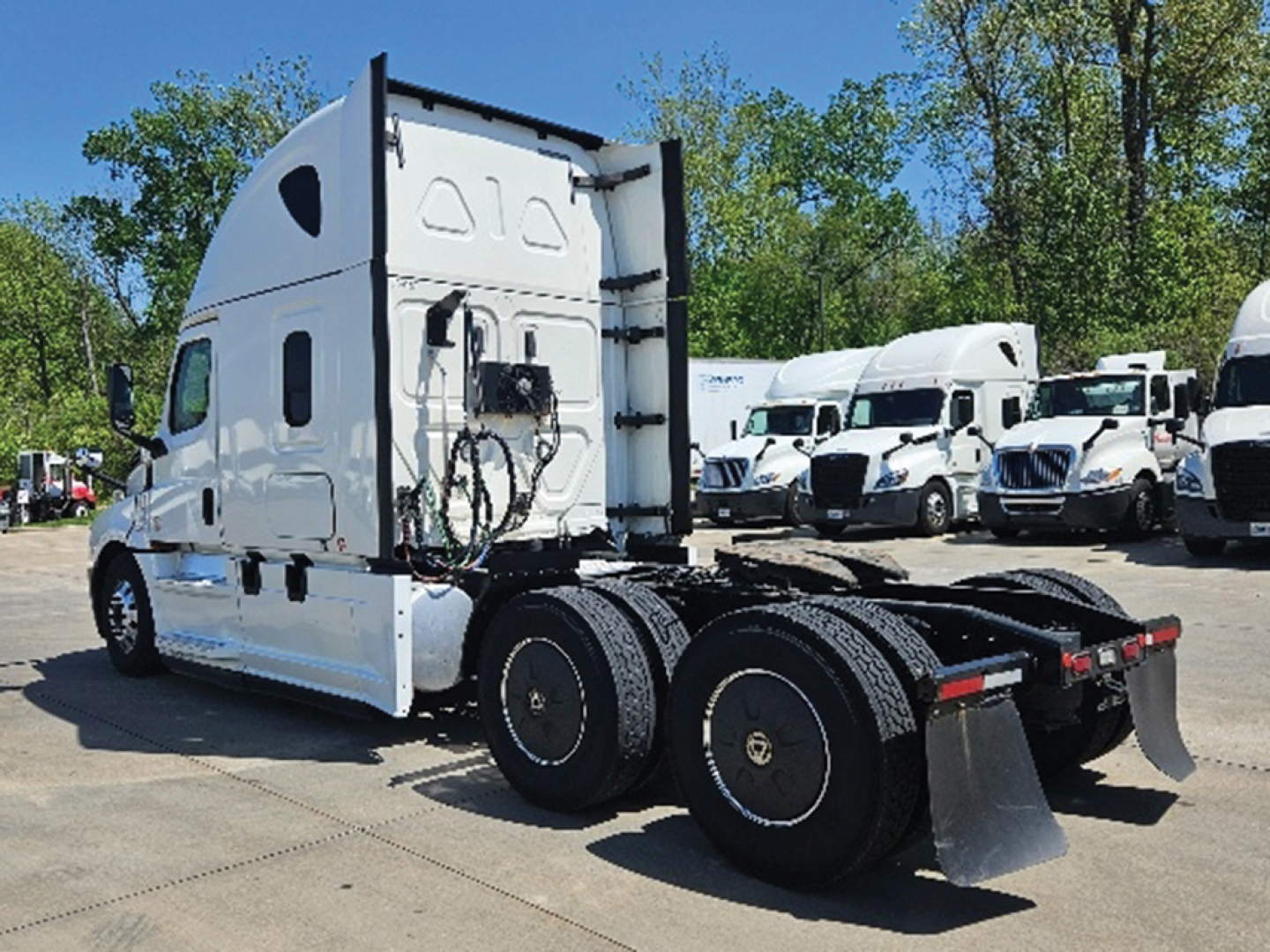 Truck rear view of a white 2020 Freightliner Cascadia126 sleeper tractor with dual rear axles and fifth wheel, stock number 549377.