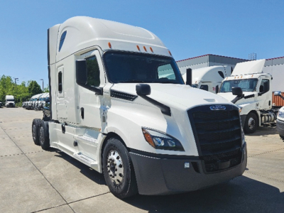 Freightliner Cascadia126 truck in white two-axle day cab with sleeper cab, front view showing cab grille and headlights.