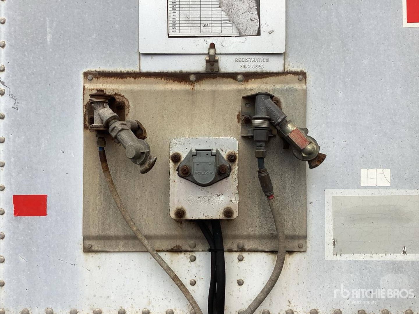 Trailer electrical receptacle panel showing two round plugs and wiring on a Wabash DVDBHPC trailer