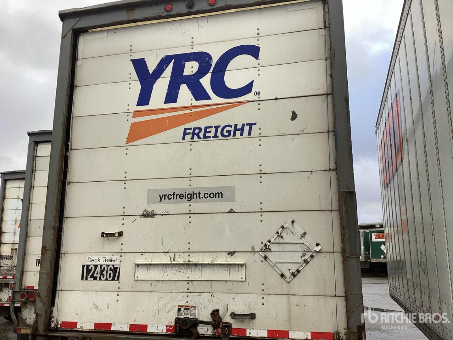 Trailer rear showing YRC Freight branding with dock area and plate; text includes stock number 124367 and a diamond-shaped placard area.