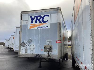 Trailer hitch area of a used Wabash DVDBHPC trailer with YRC Freight logo on the back, surrounded by other trailers in a lot.