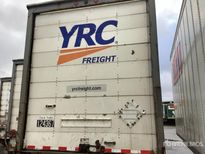 Trailer rear showing YRC Freight branding with dock area and plate; text includes stock number 124367 and a diamond-shaped placard area.