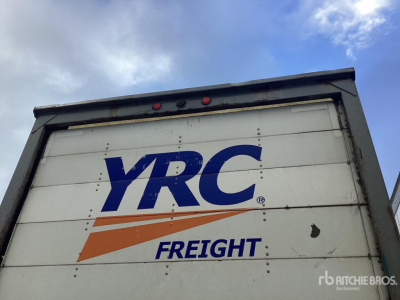 Trailer with YRC Freight logo on rear doors showing blue YRC letters and orange swoosh; white background, black top edge, small red lights.