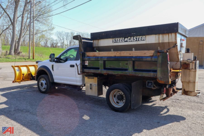 Ford F-550 dump truck with plow and spreader, side view showing steel hopper and rear mounted spreader.