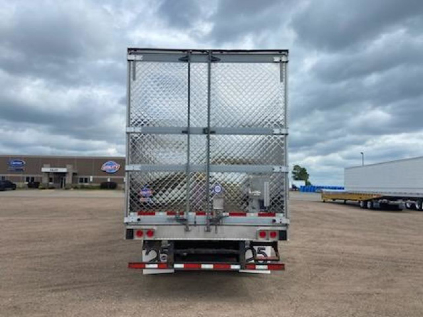 Utility reefer trailer back view showing diamond plate metal doors and rear lights.