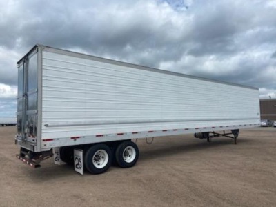 Utility reefer trailer side view showing tandem axle, silver metal walls, and rear doors.