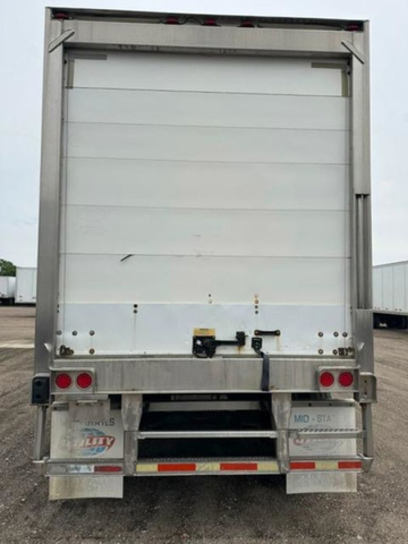 Rear view of a 2005 utility refrigerated trailer showing opaque white roll-up doors and lower bumper with reflectors.
