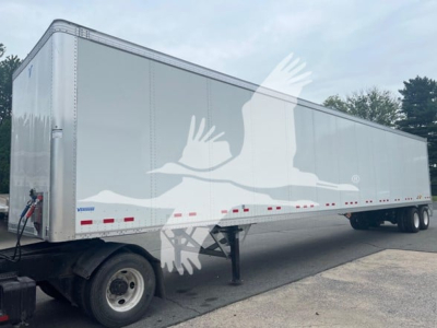 Vanguard VXP plate van trailer showing side view with silver exterior and dual rear axles.