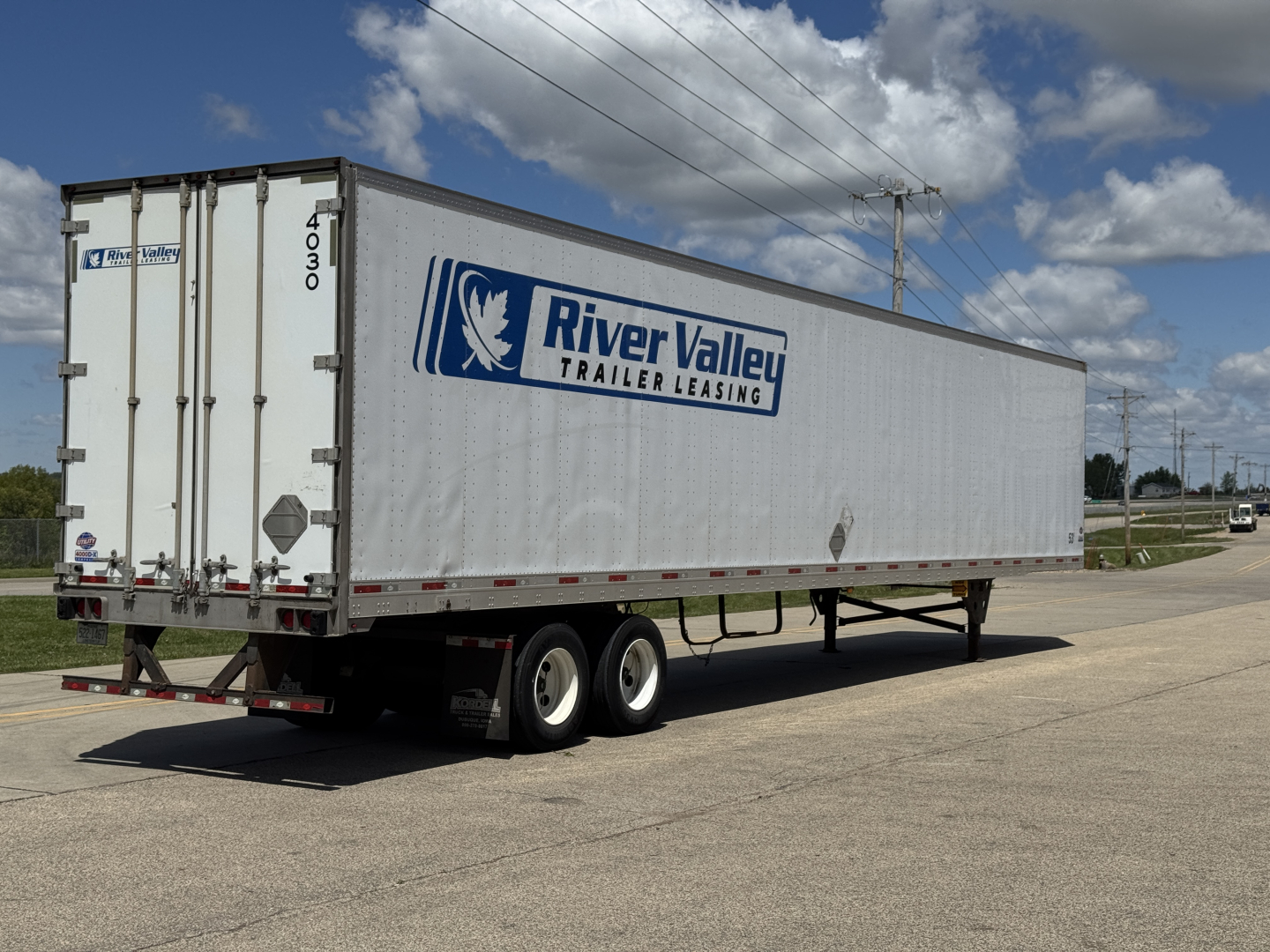Trailer side and rear showing River Valley Trailer Leasing logo on a long box trailer, dual rear doors, 4030 stock, 2014 Utility 4000DX trailer in a parking lot.