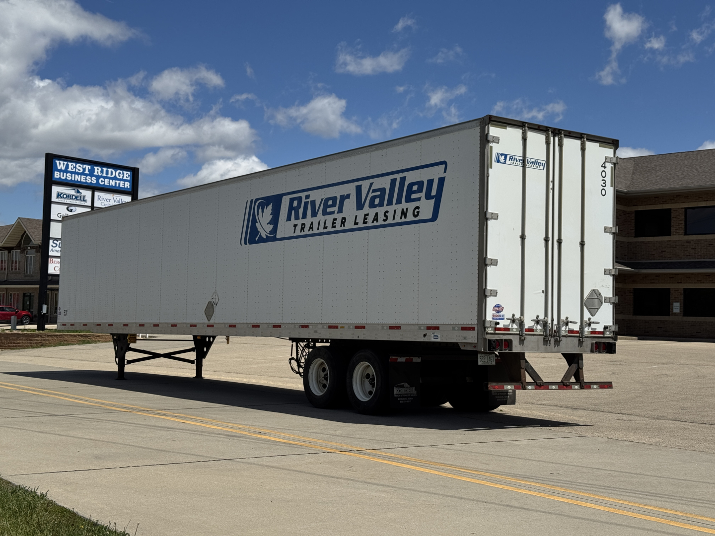Trailer side and rear showing River Valley Trailer Leasing logo on a white 2014 Utility 4000DX trailer with dual rear doors and support legs.