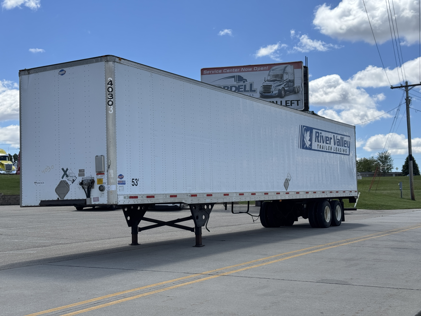 Utility trailer 4000DX side view showing River Valley trailer logo and rear doors.