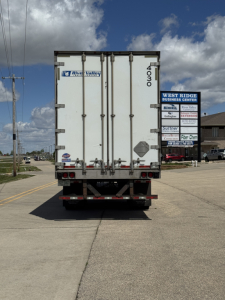 Trailer rear view of a 2014 Utility 4000DX trailer with stock number 4030-1 and VIN 1UYVS2534EP898228 in a dealership lot.