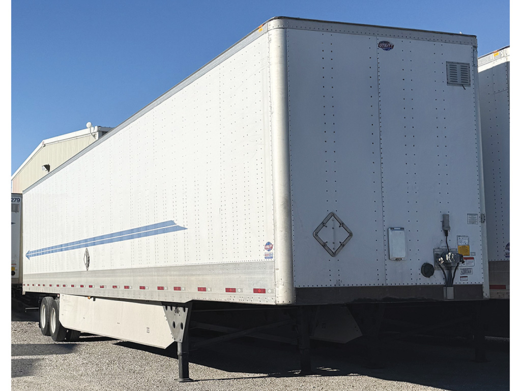 Utility 4000D-X tall bottom rail trailer side view showing white cargo box and rear end with support legs and hitch.