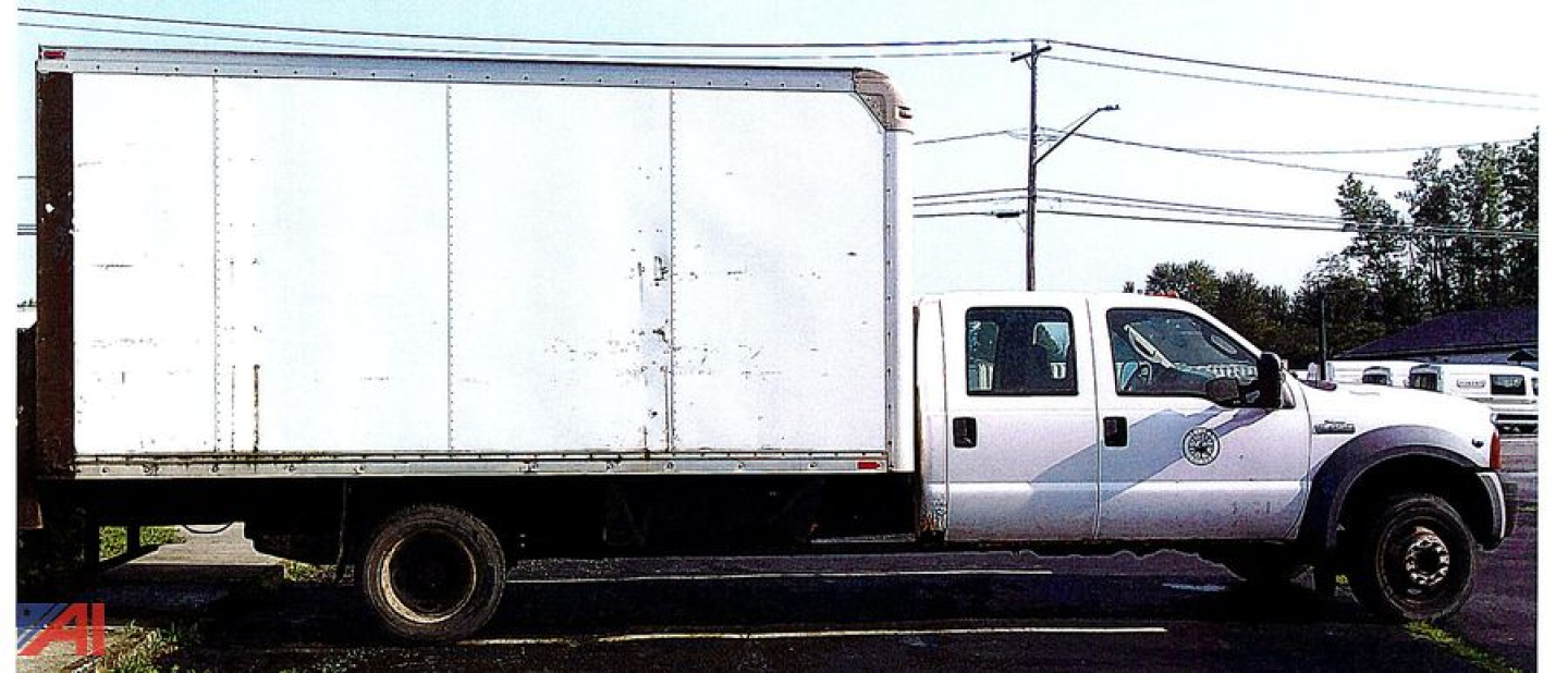 Box truck side view showing 2006 Ford F-450 Super Duty Crew Cab with box body and white cab.