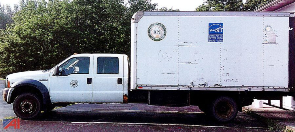 Ford F-450 Super Duty crew cab box truck in service showing cargo box and white cab.